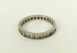 A DIAMOND SET ETERNITY RING, white metal shank set with round cut channel set diamonds, ring size '