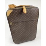 LOUIS VUITTON 70 SUITCASE, monogram canvas on rolling wheels, 68cm H x 24cm D x 43cm L.