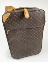 LOUIS VUITTON 70 SUITCASE, monogram canvas on rolling wheels, 68cm H x 24cm D x 43cm L.