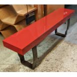 DECCA BENCH, red lacquer on shaped metal support, bears plaque, 150cm x 28cm x 46cm H.