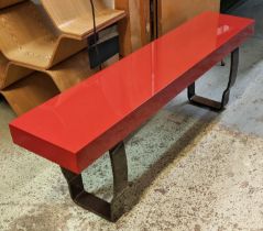 DECCA BENCH, red lacquer on shaped metal support, bears plaque, 150cm x 28cm x 46cm H.