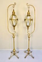 STORM LANTERNS ON STANDS, a pair, 163cm high, 35cm wide, Regency style, gilt metal. (2)