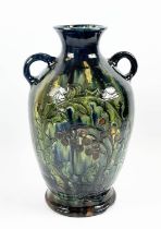 C.H. BRANNAM BURUMWARE POTTERY VASE, incised decoration of leaves and berries in blue, green,