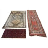 ANTIQUE RUGS, a collection of three, largest 330cm x 97cm. (3)
