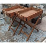 DRINKS TRAY TABLES, a pair, stamped with various champagne houses, 65cm x 44.5cm x 78.5cm. (2)