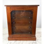 COLLECTORS CABINET, Victorian mahogany with six graduated drawers behind arched glazed door on