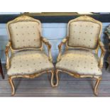 OPEN ARMCHAIRS, a pair, 62cm x 103cm H, Louis XV style with gilt carved frames.