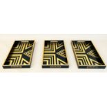 COCKTAIL TRAYS, 5cm high, 40cm wide, 25cm deep, Art Deco style gold geometric designs. (3)