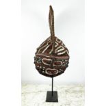 A ZAMBIAN MAKISHI CEREMONIAL MASK, made from wicker and bark cloth with black bees wax and natural