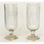 STORM LANTERNS, a pair, cylindrical cut and engraved glass on stepped plinth bases, 40cm H. (2)