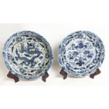 CHARGERS ON STANDS, a pair, Chinese export style blue and white ceramic, chargers 51cm diam.,