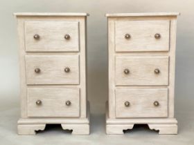 BEDSIDE CHESTS, a pair, traditionally grey painted each with three drawers and bracket supports,