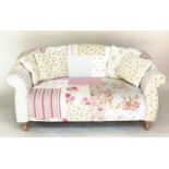 SOFA BY CATH KIDSTON, two seater Victorian style patchwork with scroll arms and turned supports (