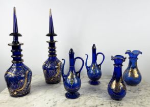 BOHEMIAN DECANTERS, a pair, blue glass with gilt decoration and stoppers, two shaped lipped vases