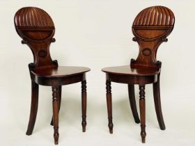 HALL CHAIRS, a pair, Regency mahogany with 'balloon' reeded and 'C' scroll backs, panel seats and