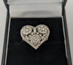 AN 18CT WHITE GOLD DIAMOND DRESS RING, the head in the form of a heart, encrusted with round