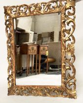 FLORENTINE WALL MIRROR, Italian carved giltwood, pierced foliate frame and bevelled mirror plate,