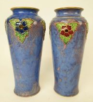 A ROYAL DOULTON PAIR OF VASES, 1920s, designed by Lily Partington, of tapered form, raised foliage