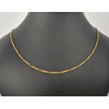 A YELLOW METAL BAR-LINK NECKLACE, each link spiral engraved, 76cm long, 15.74 grams.