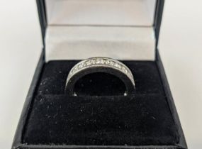 A DIAMOND SET WHITE METAL ETERNITY RING, set with 24 round brilliant cut diamonds, channel set, each