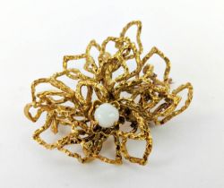 A YELLOW METAL ABSTRACT SPIDERS WEB BROOCH, set with a single opal cabouchon, early 20th century,