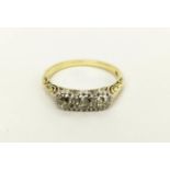 A 14CT GOLD THREE STONE DIAMOND RING, each stone of approximately 0.10 carats, ring size Q, 4 grams.
