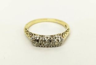 A 14CT GOLD THREE STONE DIAMOND RING, each stone of approximately 0.10 carats, ring size Q, 4 grams.