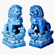 FOO DOGS, a pair, 40cm high, 15cm wide, 25cm deep, cobalt blue glazed ceramic.