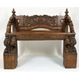 RAJASTHANI BENCH, antique Indian hardwood, profusely carved with elephant head detail arms, 100cm