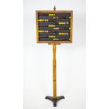 ABACUS, 146cm H x 51cm W, 19th century ash and polychrome with iron base.