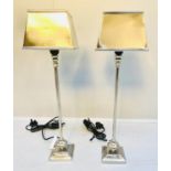 LIBRARY TABLE LAMPS, 59cm high, a pair, polished metal.