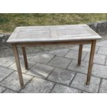 GARDEN TABLE BY LISTER, 65cm D x 109cm W x 73cm H, weathered teak, of slatted construction.