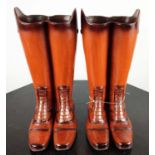 FAUX RIDING BOOTS STICK STANDS, a pair, polychrome resin, 48cm H. (2)