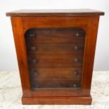 COLLECTORS CABINET, Victorian mahogany with six graduated drawers behind arched glazed door on