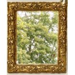WALL MIRROR, 19th century giltwood and composition, with carved oak leaf frame, 76cm x 63cm.