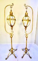 STORM LANTERNS ON STANDS, a pair, 163cm high, 35cm wide, 30cm deep, Regency style, gilt metal. (2)