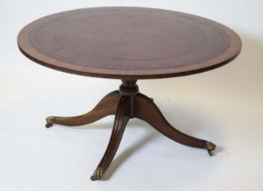 LOW TABLE, 53cm H x 100cm D, Georgian style mahogany with circular red leather top on brass castors.