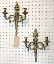 WALL LIGHTS, two pairs, gilt bronze including a pair with draped swag and flamed finial urn, swagged