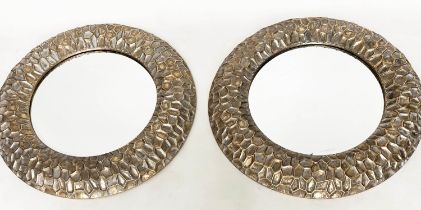 CIRCULAR WALL MIRRORS, a pair, with 'hammered' cushion gilt metal frames, 73cm W. (2)