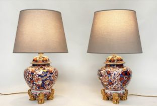 TABLE LAMPS, a pair, Imari design ceramic of lidded vase form with Dogs of Foo gilt supports (with
