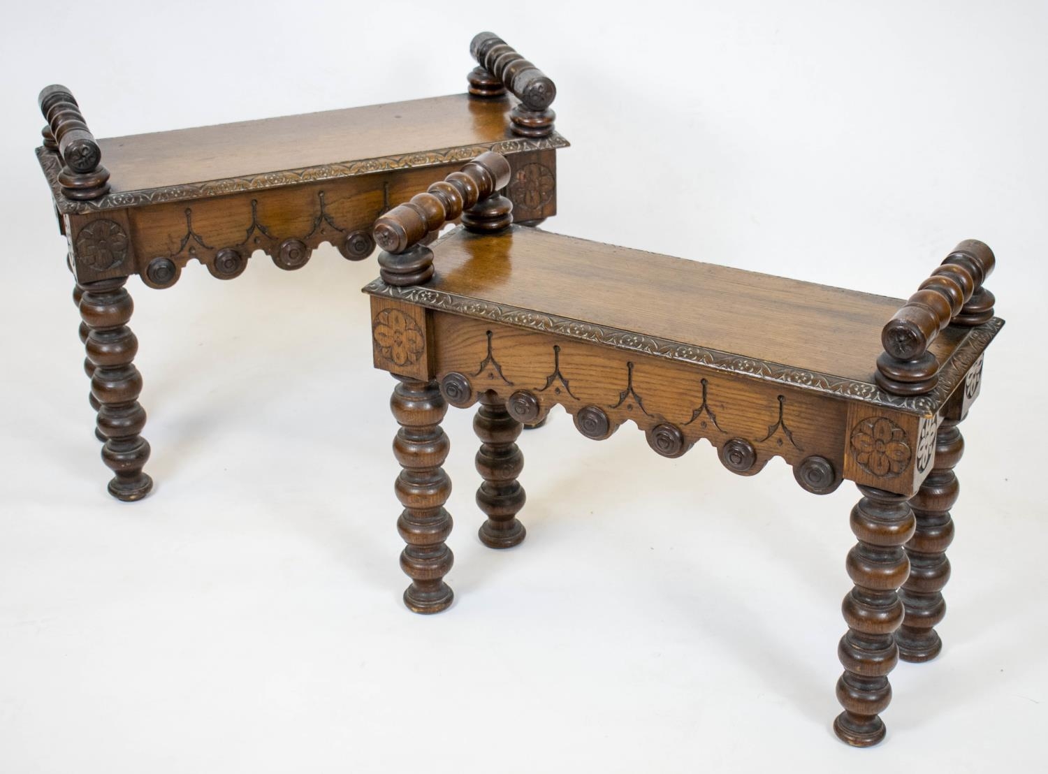 HALL BENCHES, a pair, Victorian oak each with shaped frieze and raised turned bolster arms, 64cm x