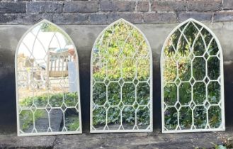 ARCHITECTURAL GARDEN WALL MIRRORS, a set of three, aged white painted frames, 76cm x 42cm. (3)