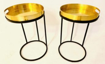 TRAY TABLES, 57cm high, 36cm in diameter, a pair, the gilt metal trays raised on black painted metal