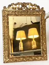 WALL MIRROR, 19th century French carved giltwood with rosette carved frame and pierced carved