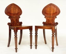 HALL CHAIRS, a pair, Regency mahogany with scroll carved backs, panel seats and turned front