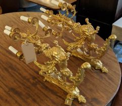 WALL LIGHTS, a pair, each 70cm H x 42cm D, gilt bronze, in the form of a winged lion. (2)