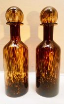 DECANTERS, a pair, 53cm high, 14cm diameter, of cylindrical form, Murano style tortoiseshell