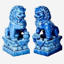 FOO DOGS, a pair, 40cm high, 15cm wide, 25cm deep, cobalt blue glazed ceramic. (2)