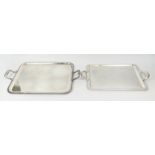 TWO CHRISTOFLE SILVER PLATED TWIN HANDLED SERVING TRAYS, largest 60cm x 39cm, complete with cloth