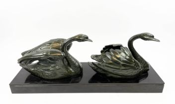 BRONZE SWANS, signed Hellert bronze on black marble base, 60cm L x 24cm H.